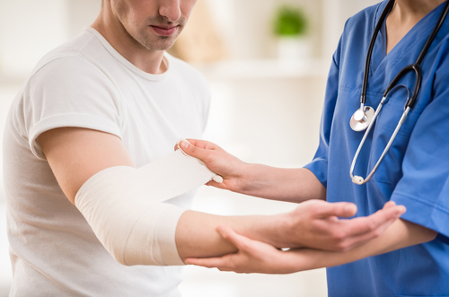 nurse assisting man from his arm injury