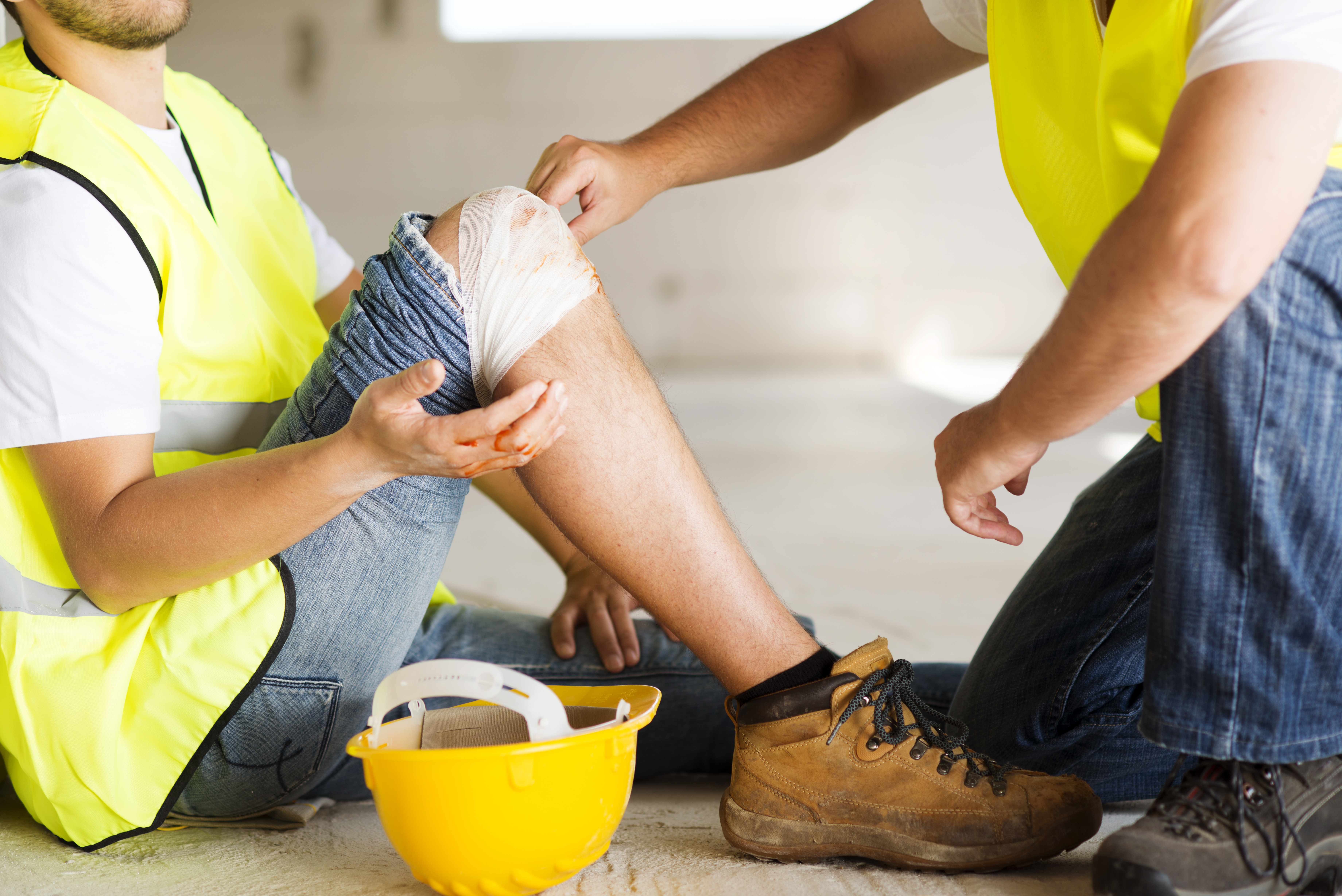 man taking care of his co-worker from injury