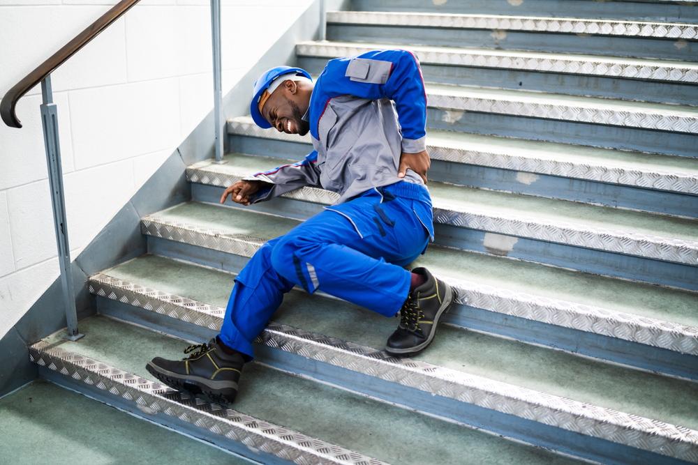 worker man lying on staircase after slip and fall accident