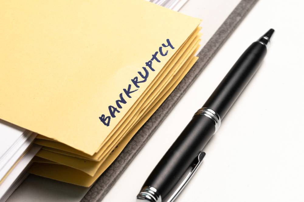 ring binder with word bankruptcy written on binding divider