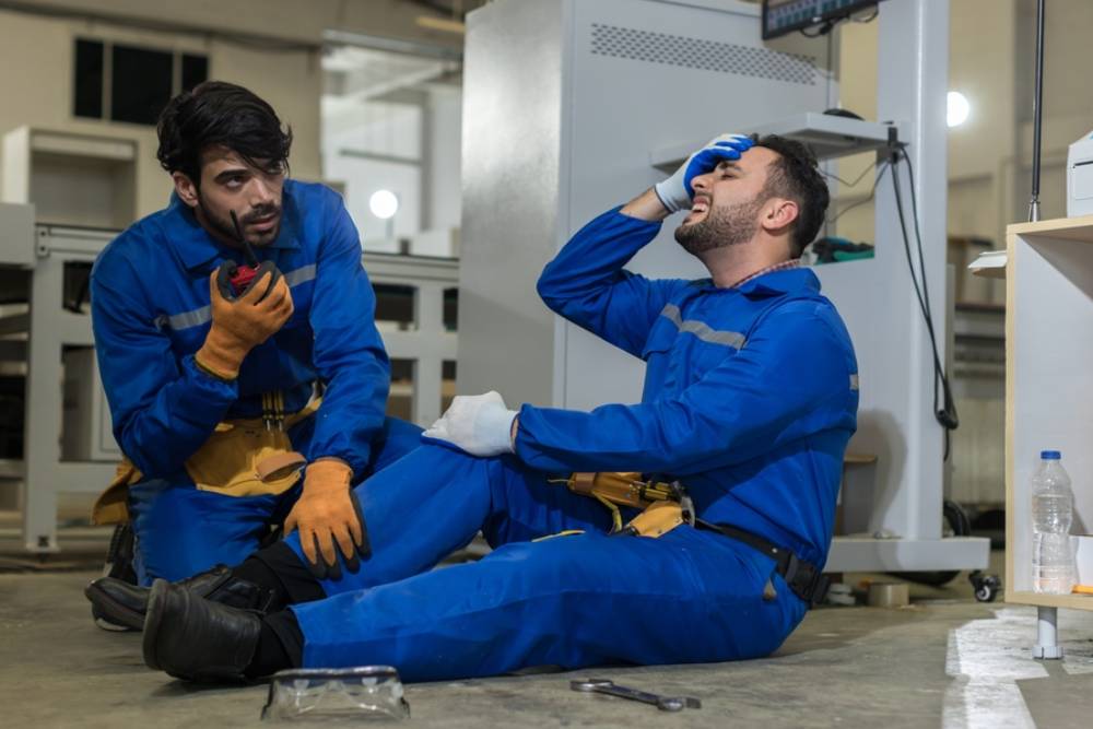 male worker has an accident on the floor in factory site