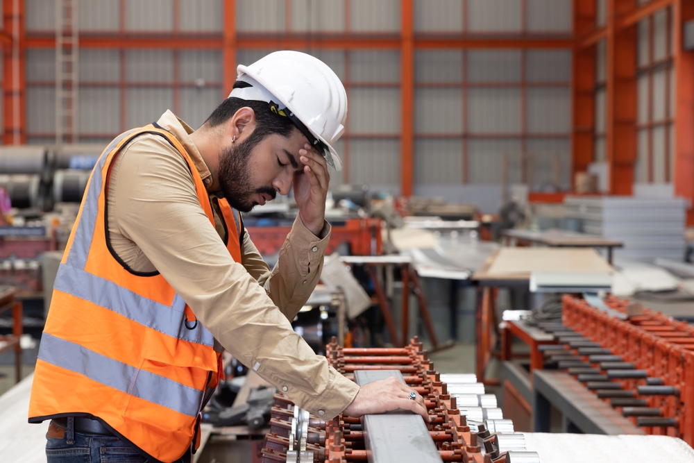 sick industrial engineer worker touch his forehead with dizziness symtom