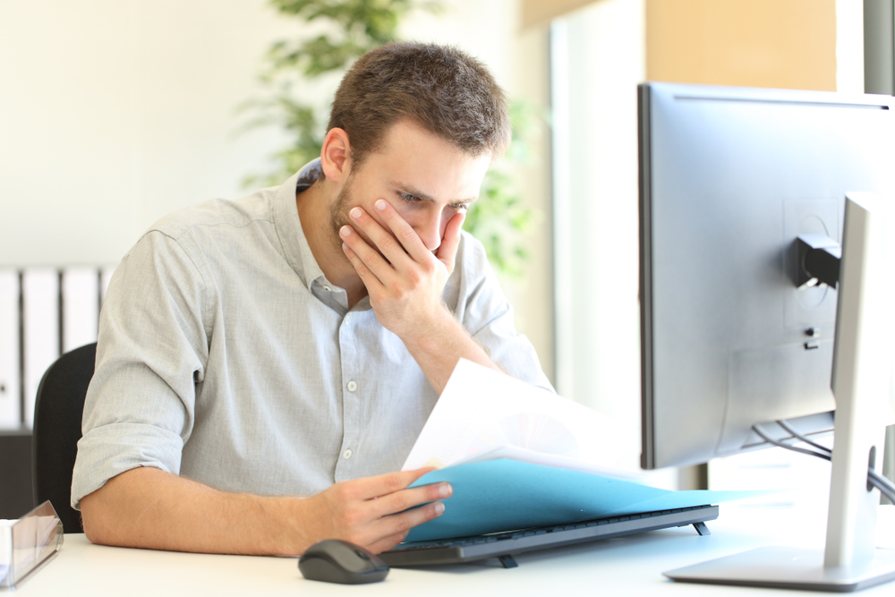 worried businessman complaining discovering mistake on document at office
