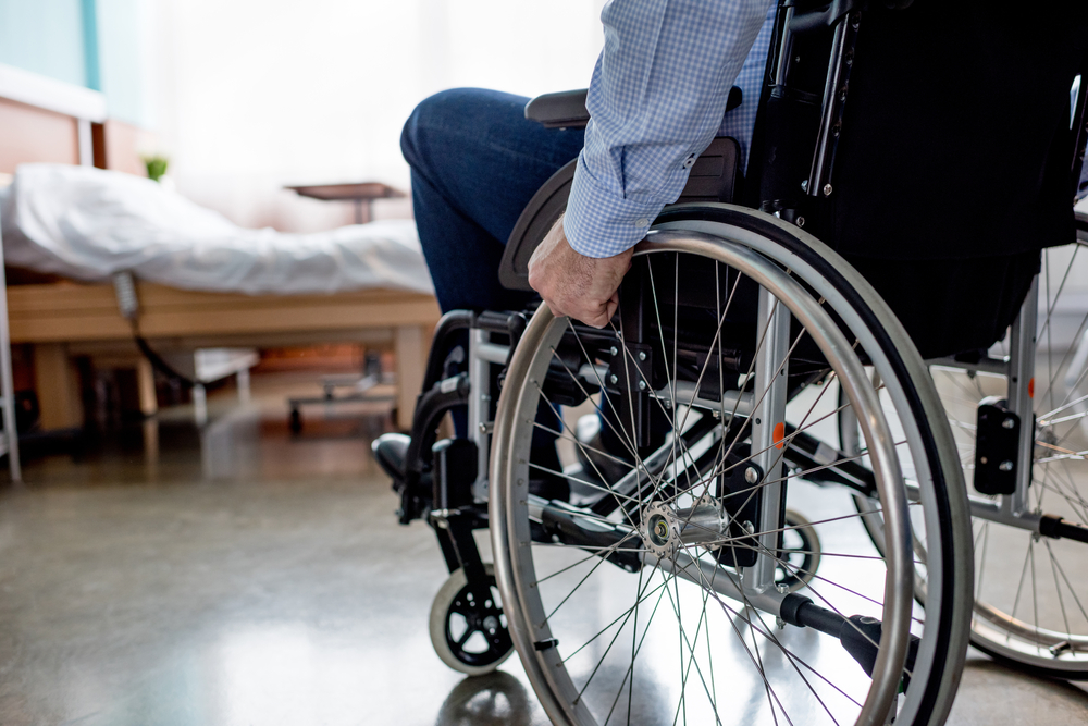 partial view of senior male patient in wheelchair at hospital
