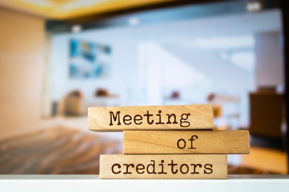 wooden blocks with words 'meeting of creditors'