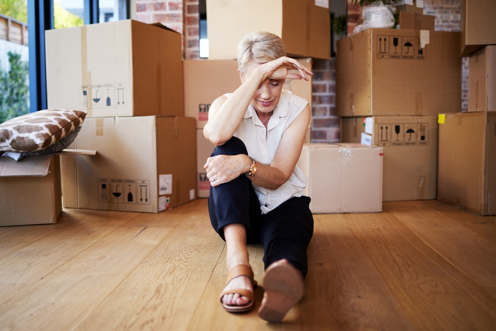 Rent, apartment and person in property, rest and thinking of mortgage of house, stress and wood