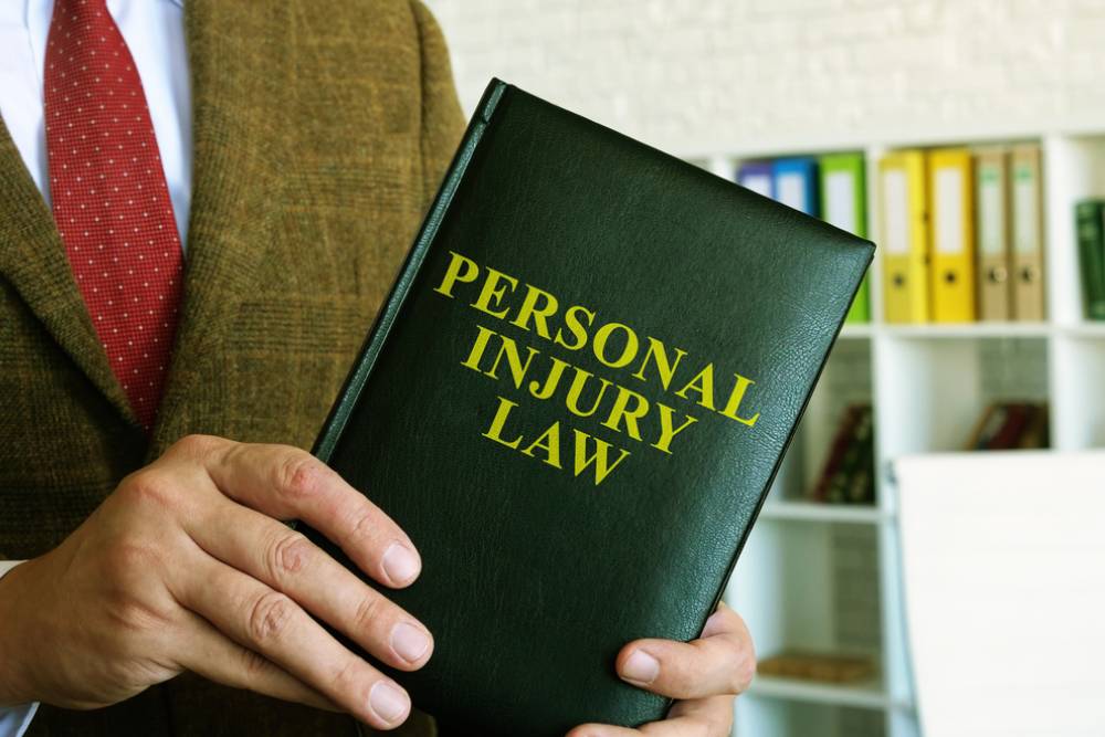 Personal injury law. A lawyer in a suit holds a book