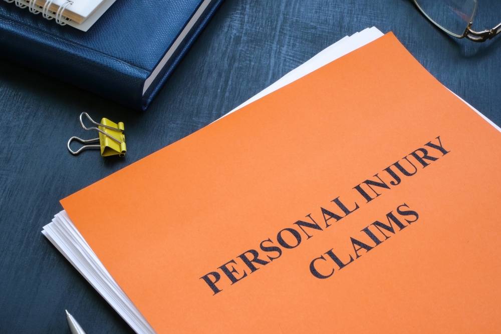A stack of papers with personal injury claims on the table