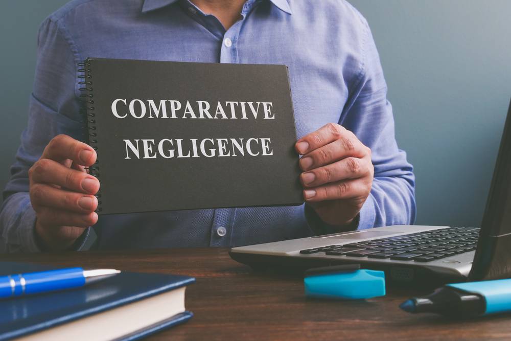 Man shows Comparative negligence data in the book.